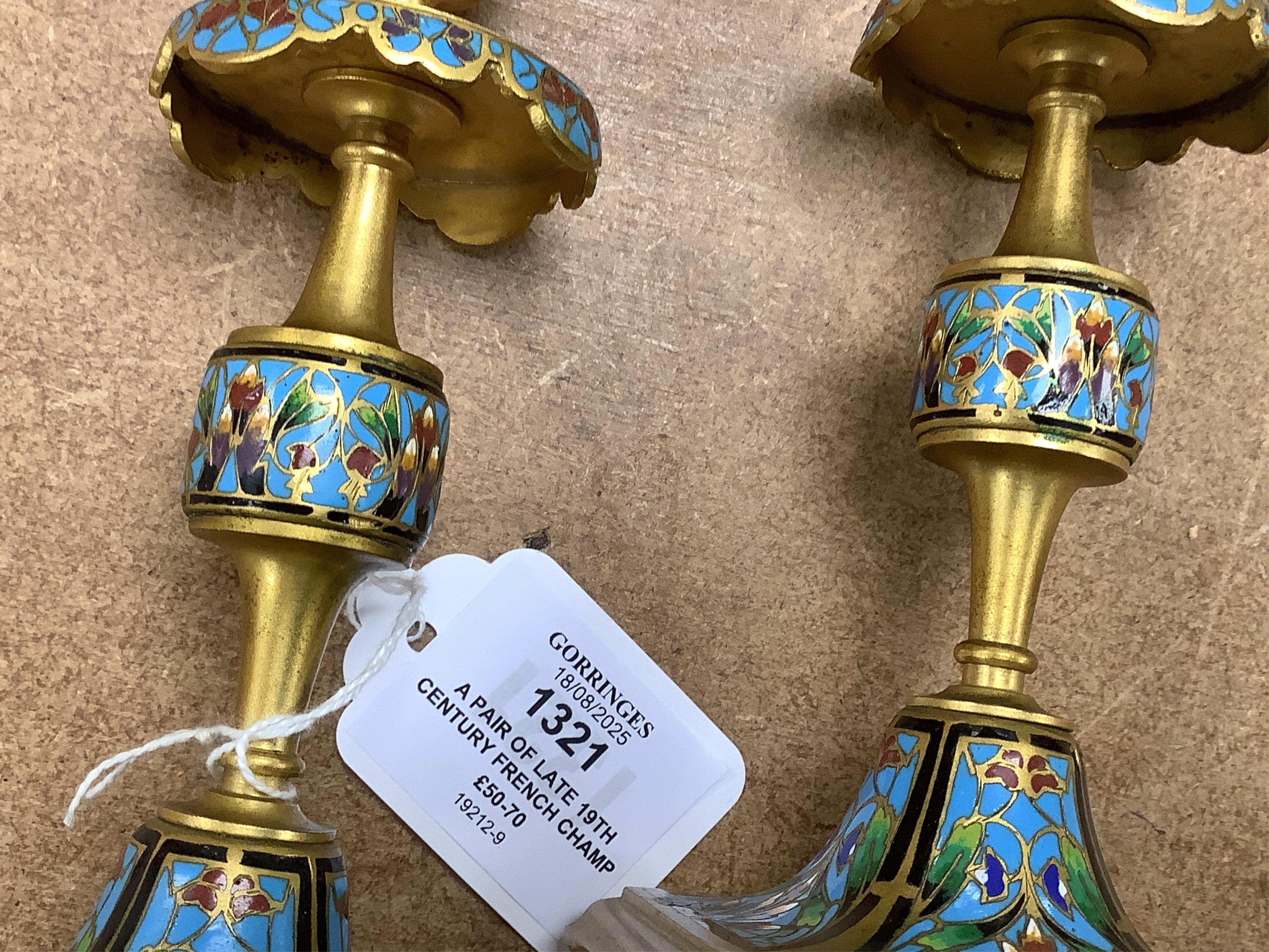 A pair of late 19th century French champleve enamel and ormolu candlesticks, 17cm